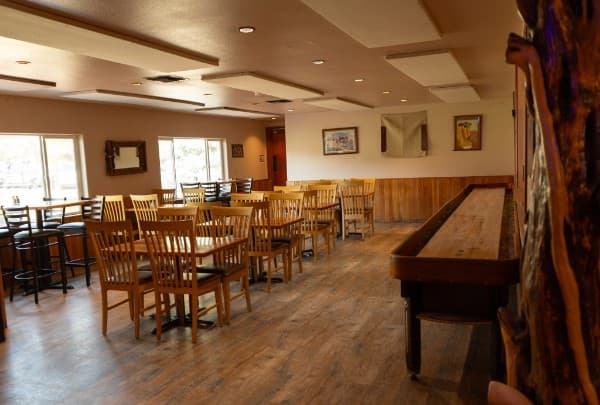 The long wooden shuffleboard table running down the side of the dining room